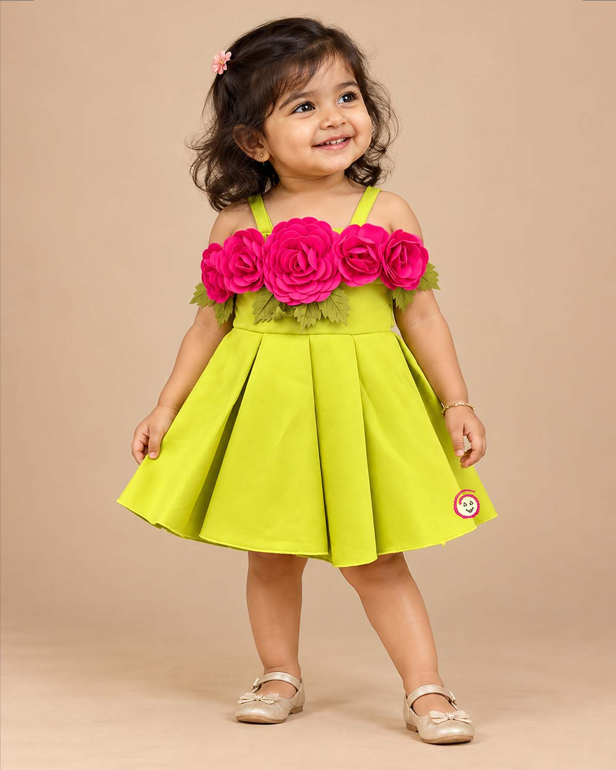 Baby party wear dress featuring oversized floral appliques and structured box pleats on a flared silhouette