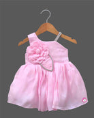 Asymmetric party frock with flower accent matching bow headband and booties set