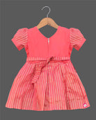 Infant cotton silk frock in peach pink with gold zari work and neckline embroidery for ear piercing ceremonies, festivals, temple visits, and weddings  