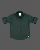 Front view of a smart collared casual shirt for toddler boys featuring roll-up sleeves and button closures against a solid background.