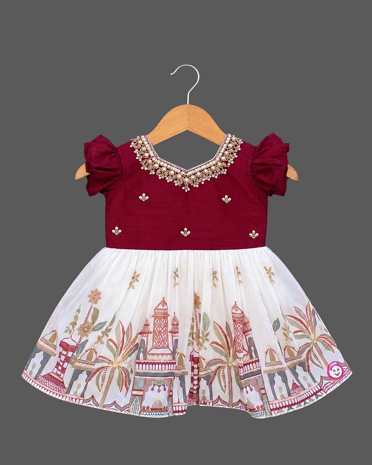 Silk frocks for baby girl with pearl beaded V-neck, flutter sleeves and printed gathered skirt on hanger