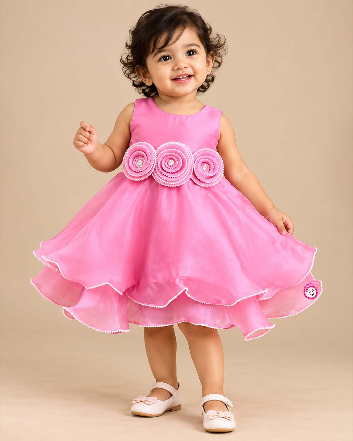 Sleeveless satin tiered party frock featuring three beaded rosettes at the waist and scalloped layered hem