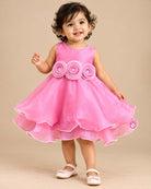 Sleeveless satin tiered party frock featuring three beaded rosettes at the waist and scalloped layered hem