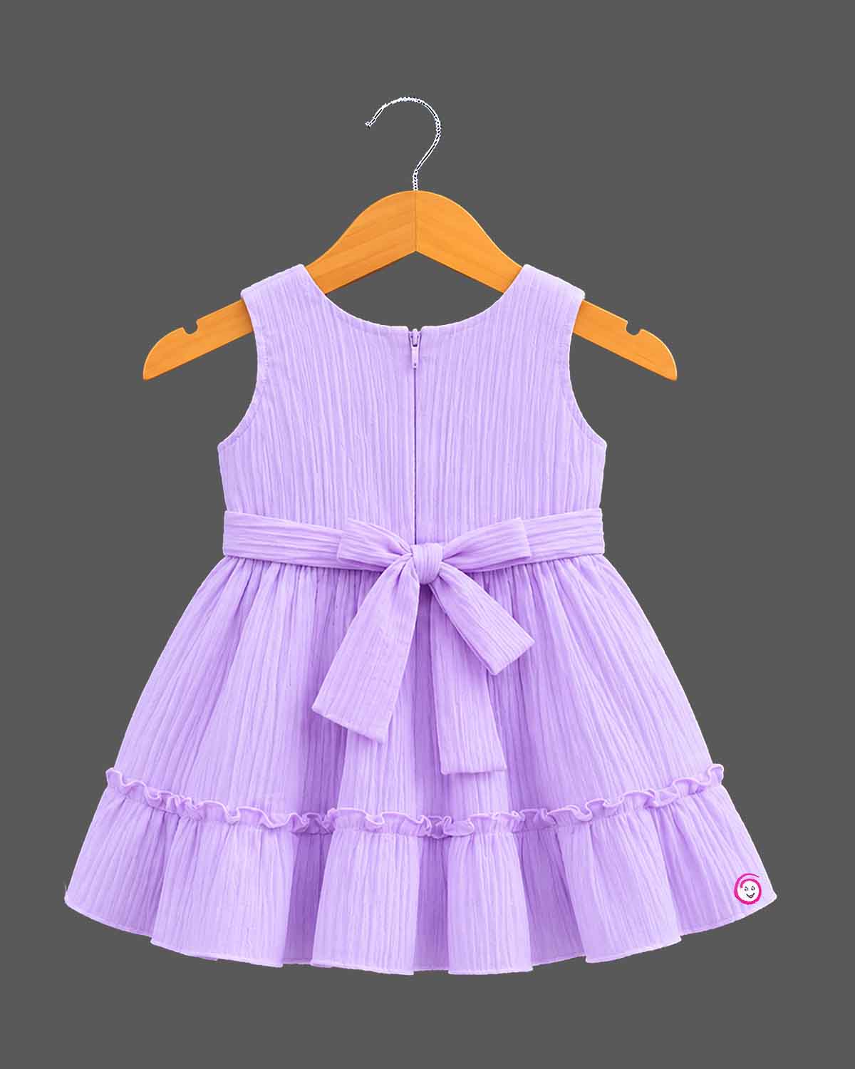 Pleated tiered frocks for baby girl featuring a side bow, lace-trimmed button placket, and round neck