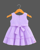 Pleated tiered frocks for baby girl featuring a side bow, lace-trimmed button placket, and round neck