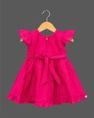 Baby party wear dress with intricate tree embroidery, frill sleeves, and pleated hemline.
