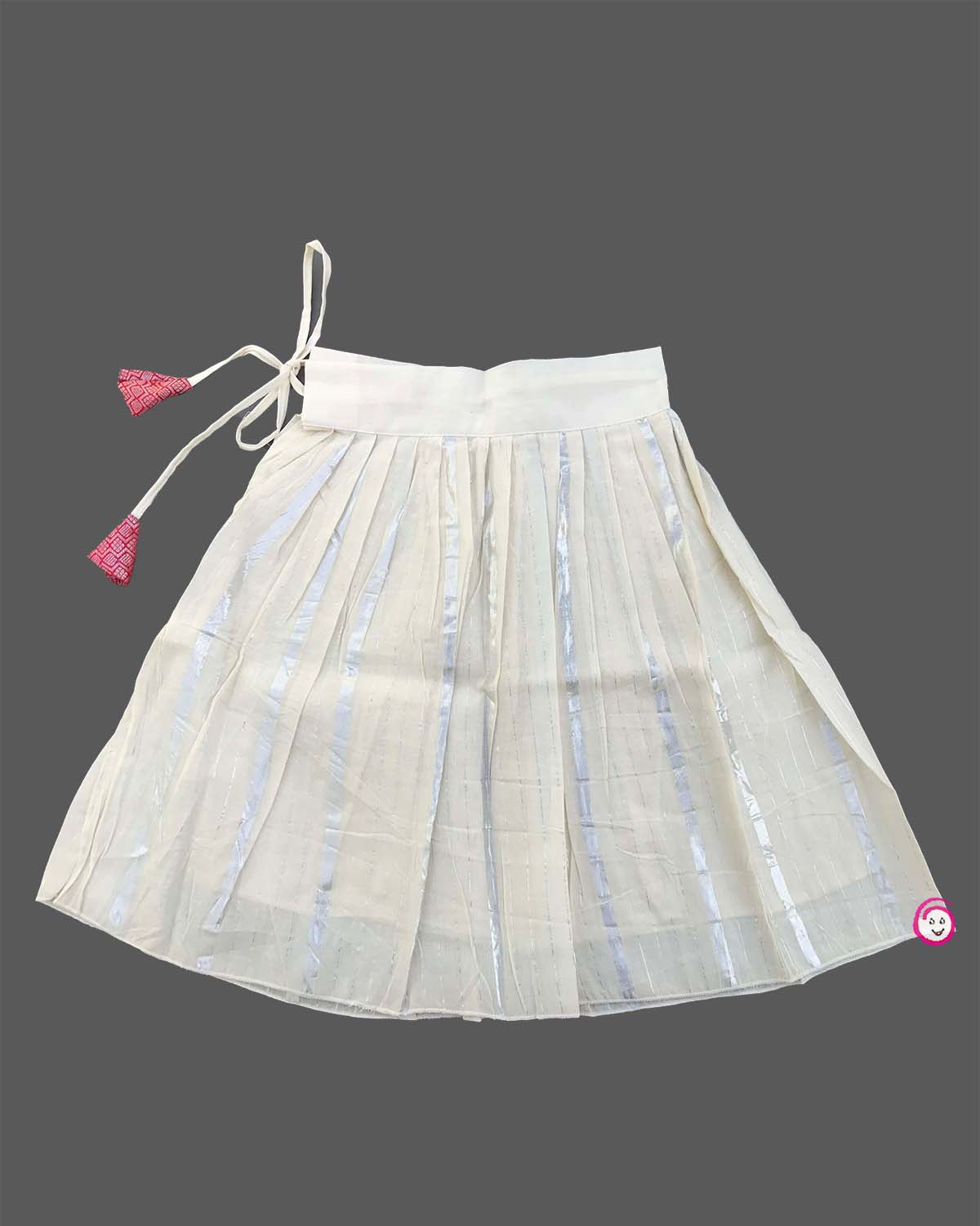 Kids festive wear featuring V neck jacquard blouse with floral brooch detail and zari pleated skirt set