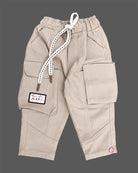 Casual utility cargo pants for little gentleman detailed with contrast stitching panels, large side flap pockets, and a patterned rope drawstring.