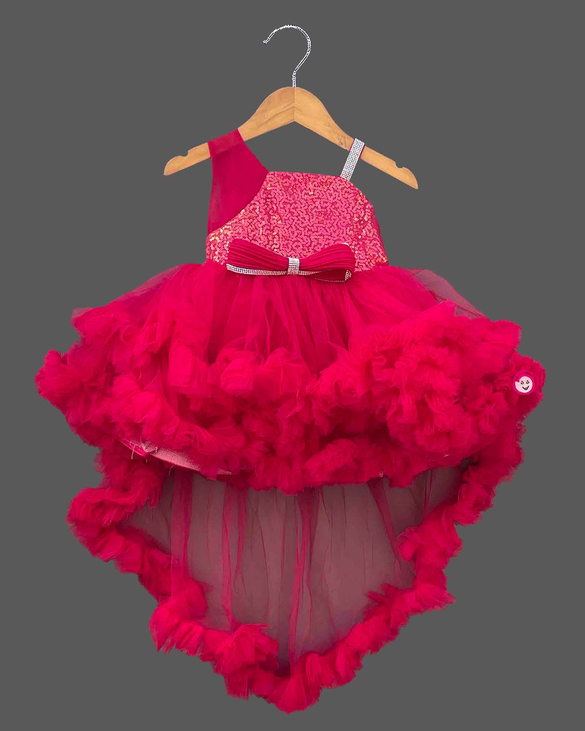 Sequined high-low baby party wear dress with layered tulle ruffle skirt and embellished strap.