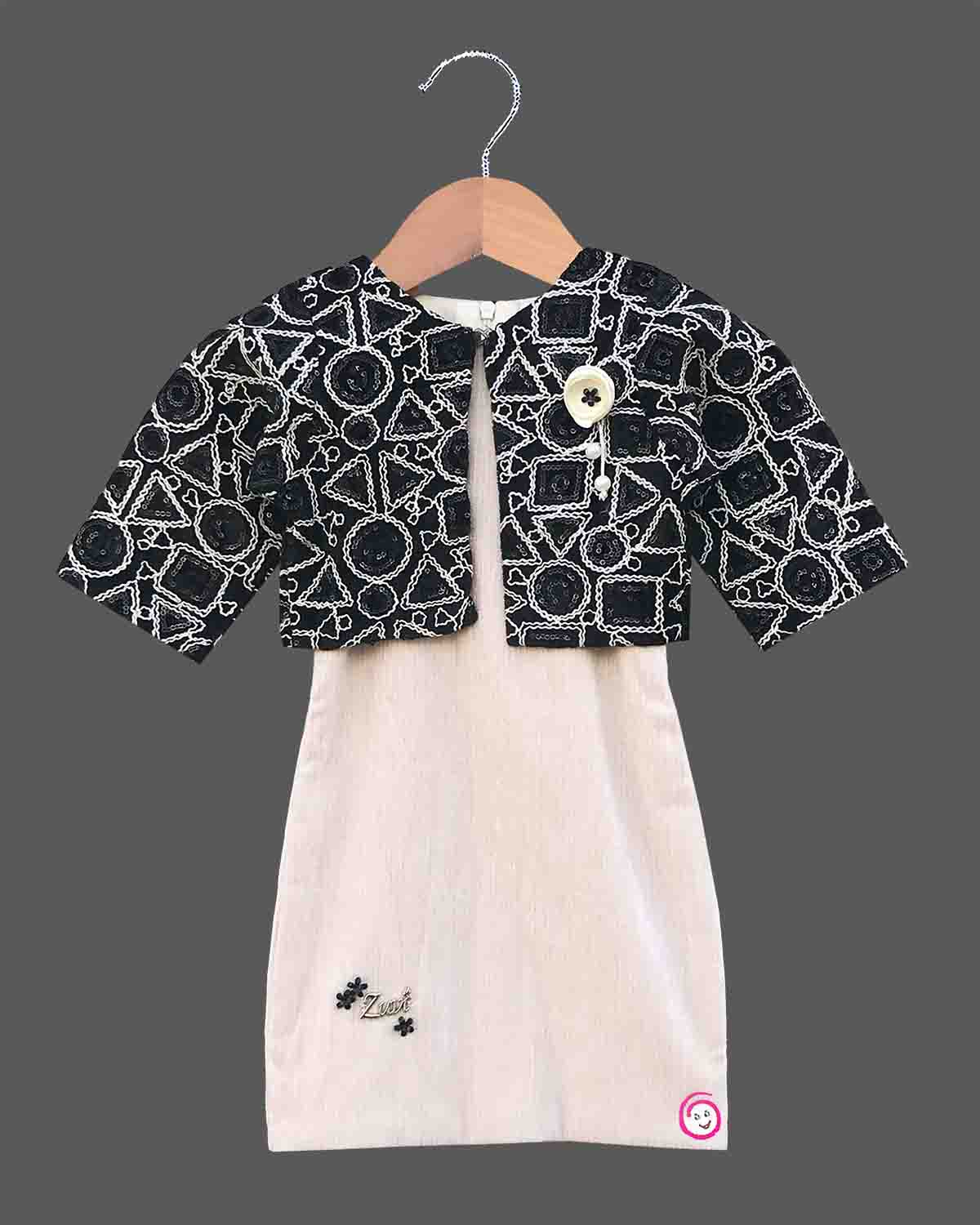 Black and white geometric jacket over a cream baby girl cotton midi dress for family dinners, evening outings, and smart casual wear