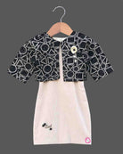 Black and white geometric jacket over a cream baby girl cotton midi dress for family dinners, evening outings, and smart casual wear