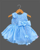 Girls organza party frock with sequined bodice, 3D shoulder flower, waist bow, and flared skirt with pearl tassels.