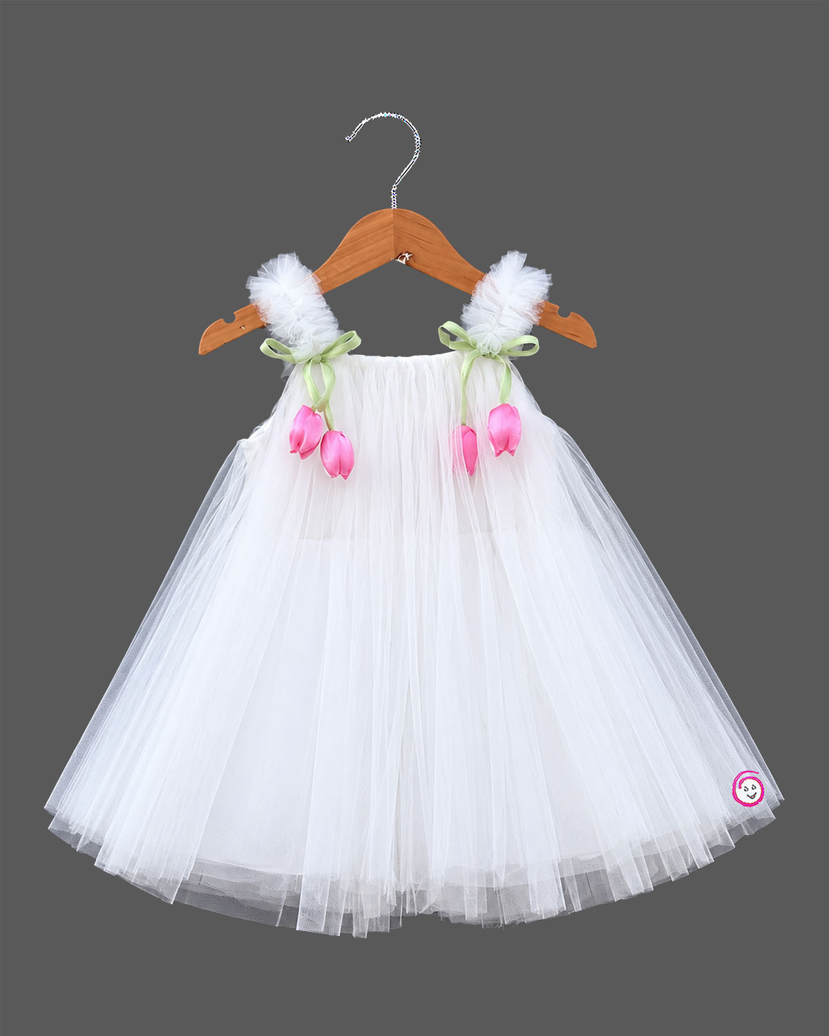 Off white net party frock with pink tulip floral accents and strap bows for girls