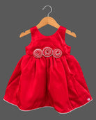 Sleeveless satin party frock with waist accents and kids party wear details.