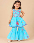 Girls sleeveless embroidered peplum kurti paired with tiered flared sharara pants featuring tassel ties.
