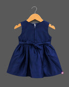 Sleeveless A-line frock with sequined waist belt and shoulder bow, styled as a baby casual wear dress.