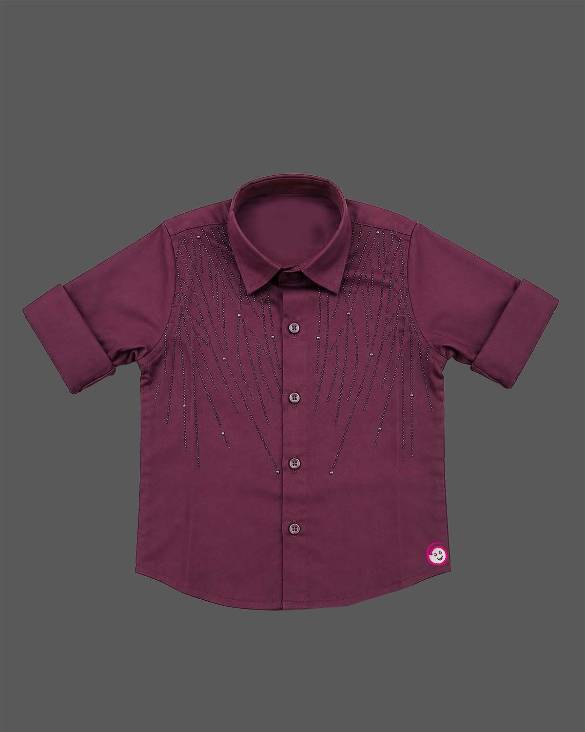 Detailed view of a boys collared party shirt embellished with elegant vertical stud patterns and roll-up sleeves.