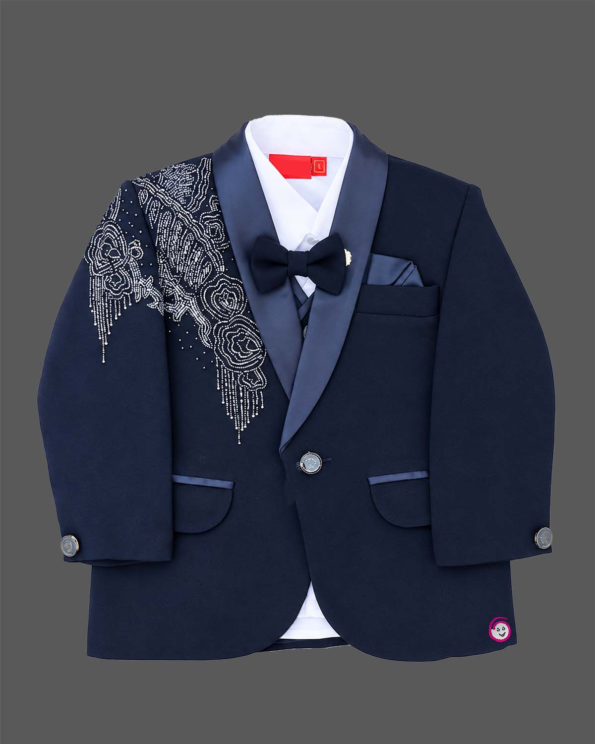 Blue boys formal suit with silver shoulder embroidery, white shirt, and bowtie