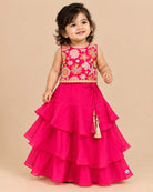 Girls floral embroidered sleeveless choli and tiered ruffle lehenga skirt set with drawstring tassel accents.