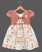 Little Girl Casual Frock featuring a cream dress with patterns and a peachish-pink textured shrug/jacket with a flower brooch and tie-up front.