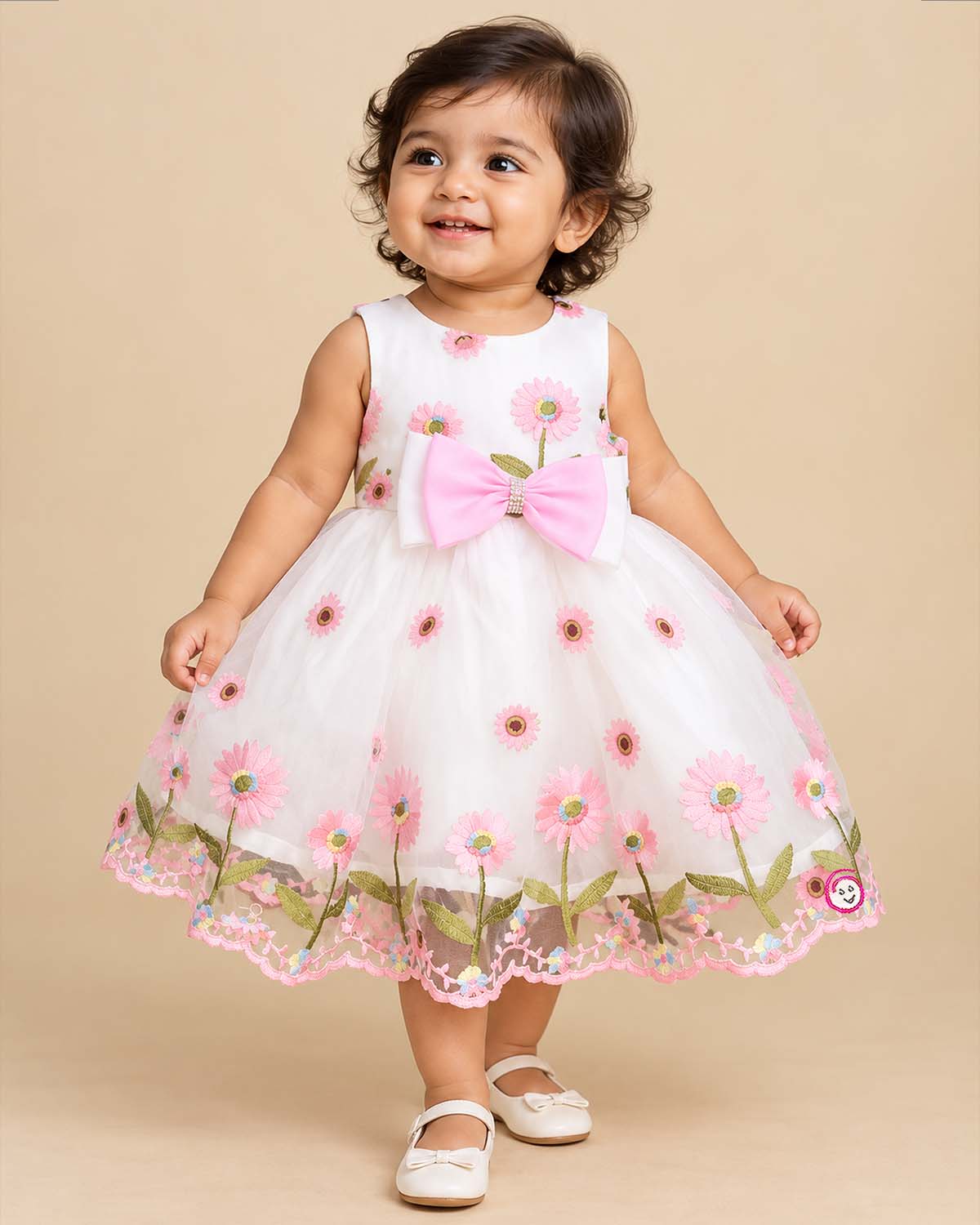 Toddler sleeveless floral embroidered tulle frock featuring a large front waist bow and flared mesh skirt overlay.