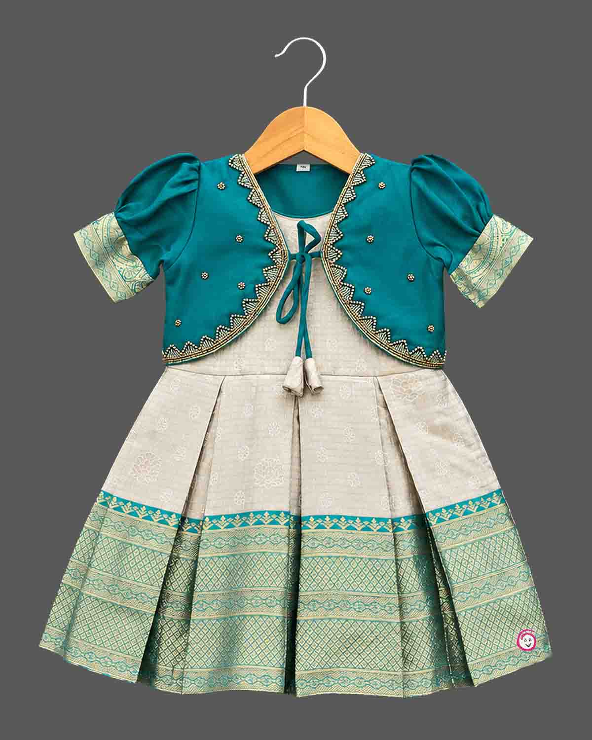 Infant silk frocks for baby girl featuring layered puffed sleeves, and ornate pleated brocade skirt.