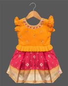 Traditional cotton silk ethnic frock for little ones featuring sequin work neckline ruffle sleeves and zari border
