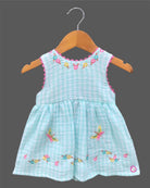 Sleeveless gingham cotton tunic dress for young girls featuring floral and butterfly embroidery with scalloped lace trim.