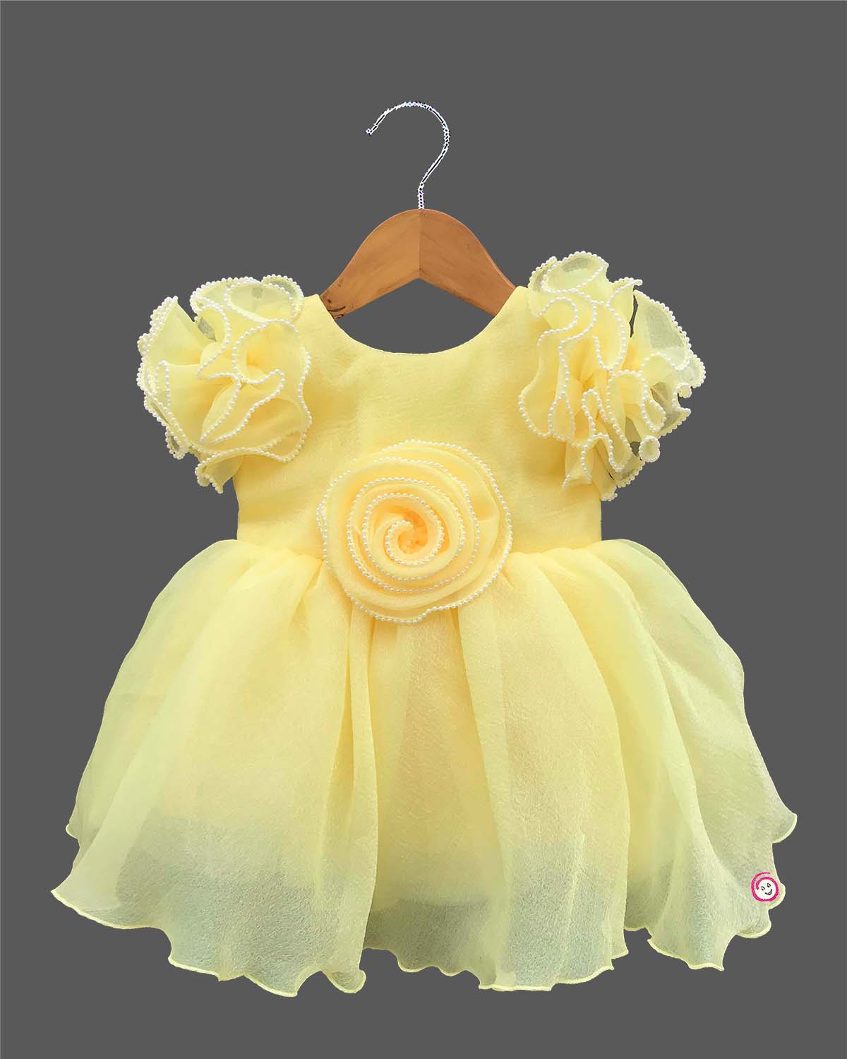 Ornate ruffled-sleeve celebration dress for a little diva with pearl-accented edges and a center floral motif.