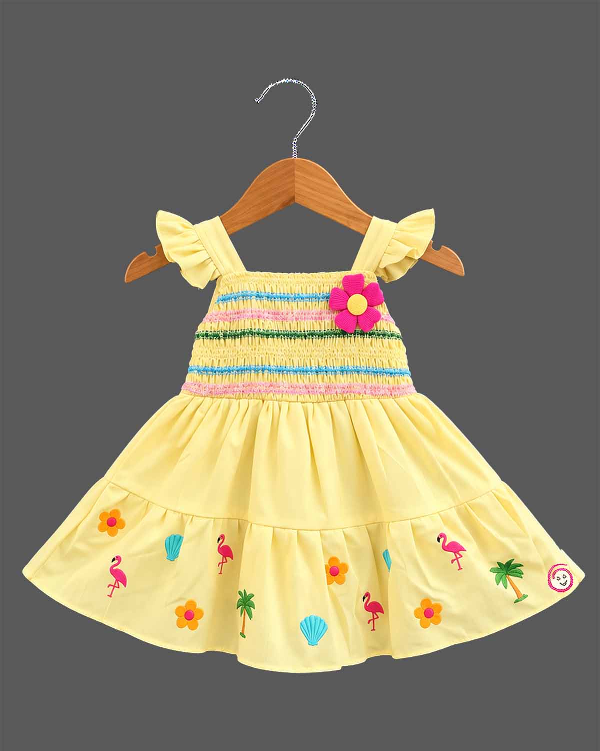 Girls smocked tropical frock with frill sleeves, flower applique, and embroidered flared hem.