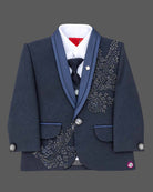 Navy blue formal tuxedo suit set for boys with crystal embellishments, shawl collar jacket, white shirt, tie, and pant for wedding party