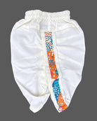 Toddler wearing an asymmetric floral print kids dhoti kurta with mandarin collar and pleated bottoms.