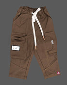 Casual utility cargo pant for young prince designed with dual flap pockets, graphic patch accent, and a thick rope drawstring waistband.
