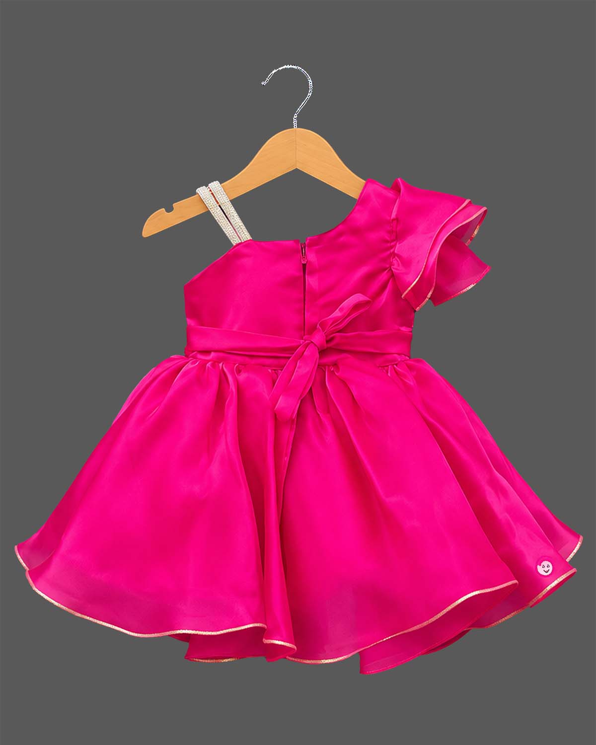One-shoulder pleated organza baby party wear dress with ruffle sleeve and floral applique.