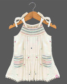 Little girl embroidered cotton frock with round neck and ribbon shoulder tie ups for birthday party and summer gathering