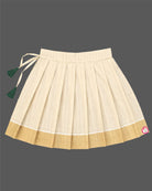 Young fashionista wearing traditional Kasavu pattu pavadai choli set with flower applique detail