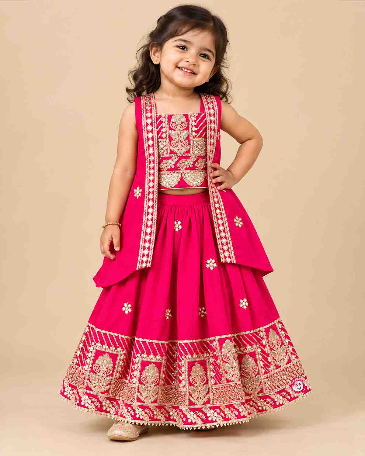 Girls embroidered choli top, flared lehenga skirt, and matching open-front sleeveless jacket.