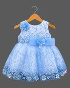 Girls embellished mesh frock with sequins, pearl brooch, floral waist appliqué, and layered net flare.
