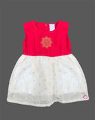 Sleeveless traditional festive attire for toddlers featuring an embroidered central emblem and a voluminous flared skirt.