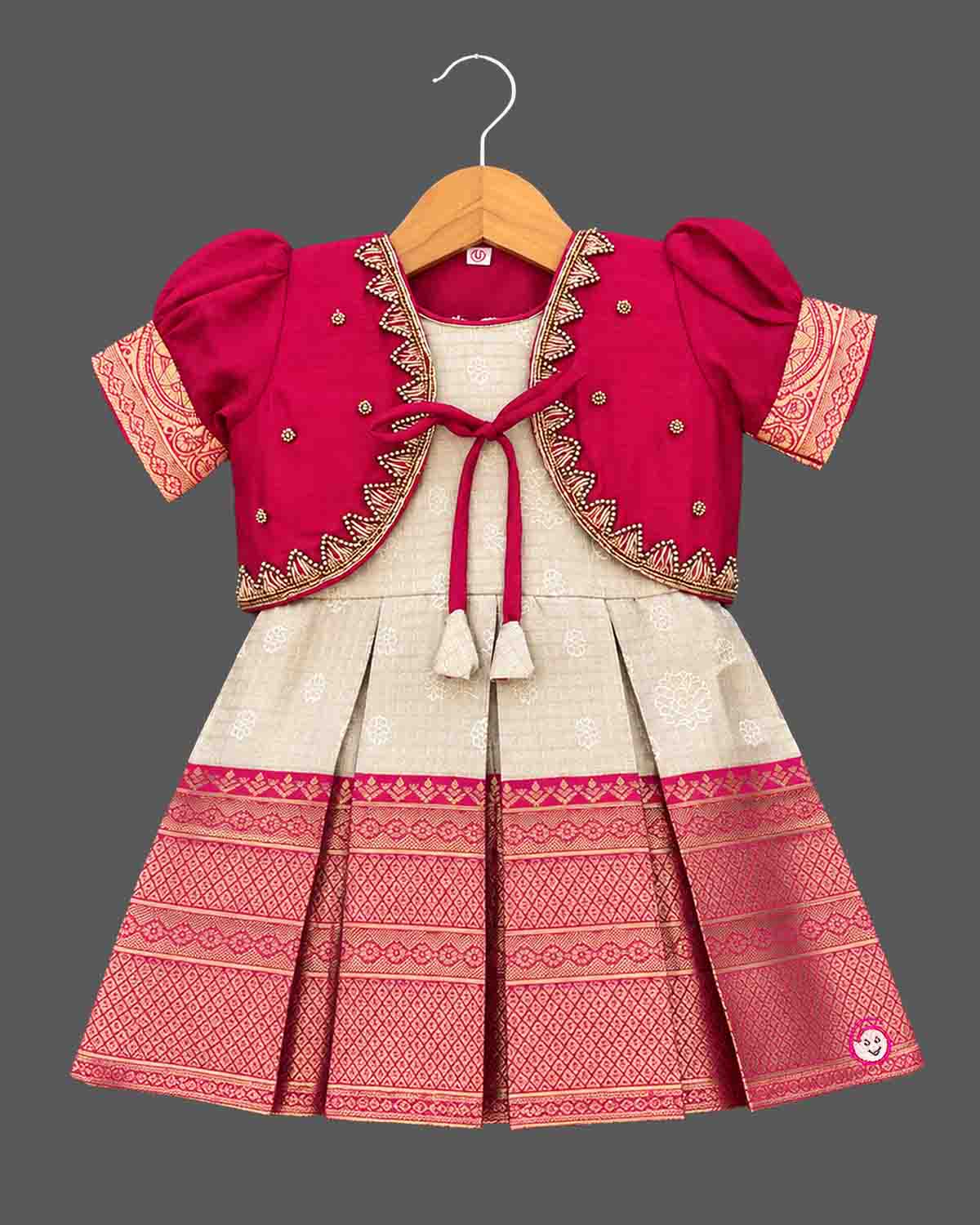 Pattu frock with beaded jacket, puff sleeves, front tassel tie and box-pleated zari border skirt for girls