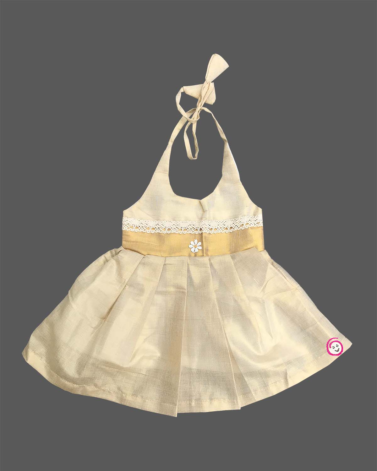 Little one wearing halter neck traditional ethnic dress with delicate lace waist trim and floral applique.