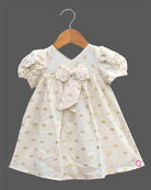 Little princess jacquard frock with front bow accent puff sleeves and woven circular motif detail