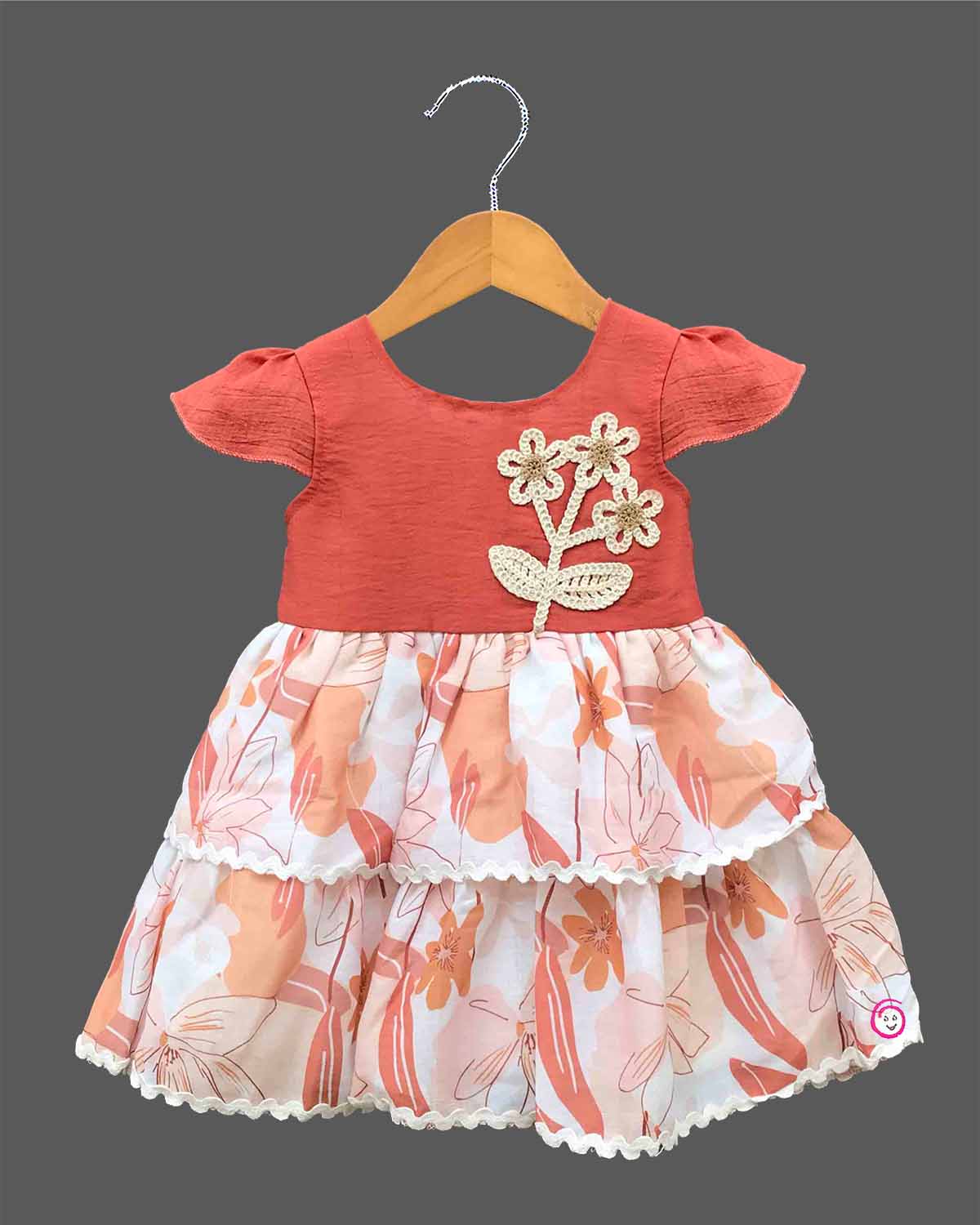 Little girl tiered printed casual frock with cap sleeves and floral crochet applique