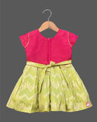 Infant cotton silk frock in magenta and lime green with traditional gold zari border and center motif embroidery for temple visits, festivals, and family functions