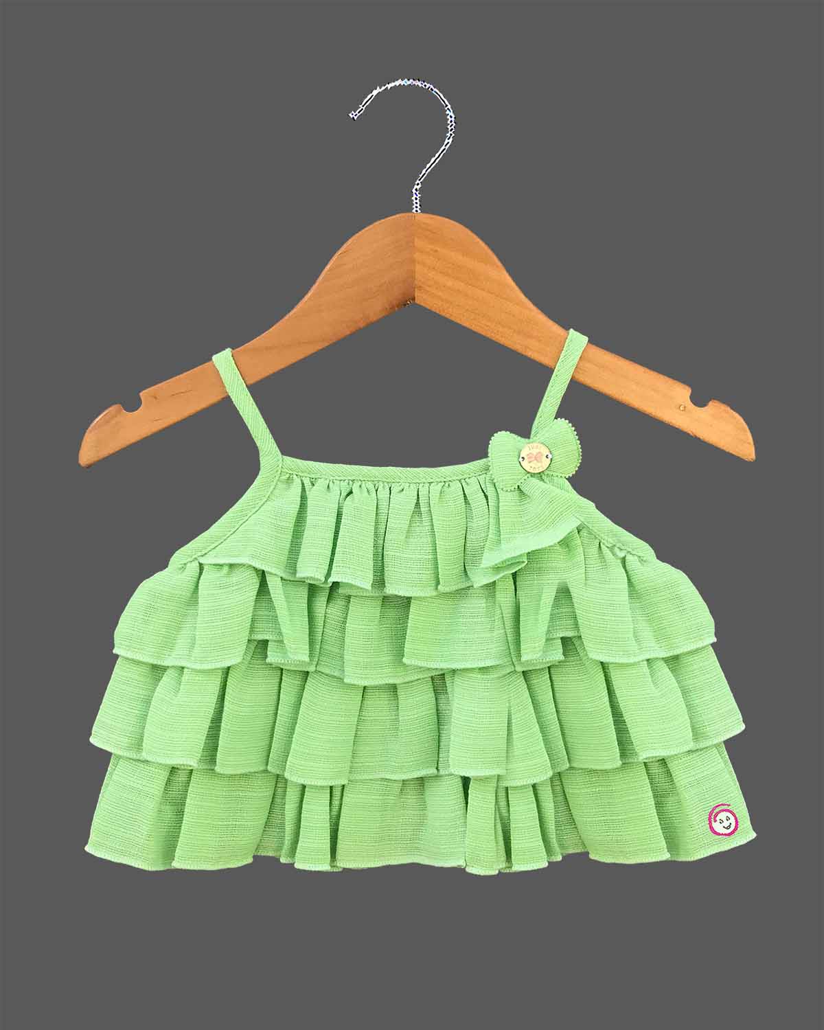 Charming top and skirt set for little princess featuring a multi-tiered ruffled strap top paired with a delicate embroidered net skirt on a hanger.