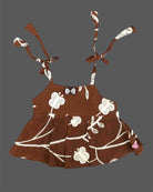 Stylish sleeveless cotton spaghetti top for baby girls with embroidered floral patterns and shoulder tie straps.