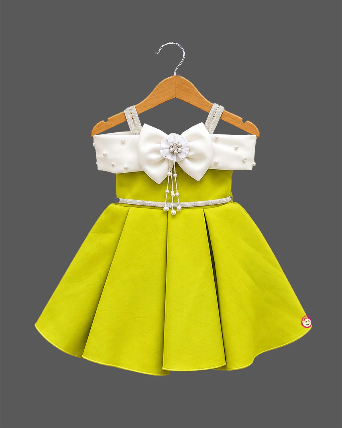 Off-shoulder bow design silk frocks for baby girl with box pleats and pearl tassel details.