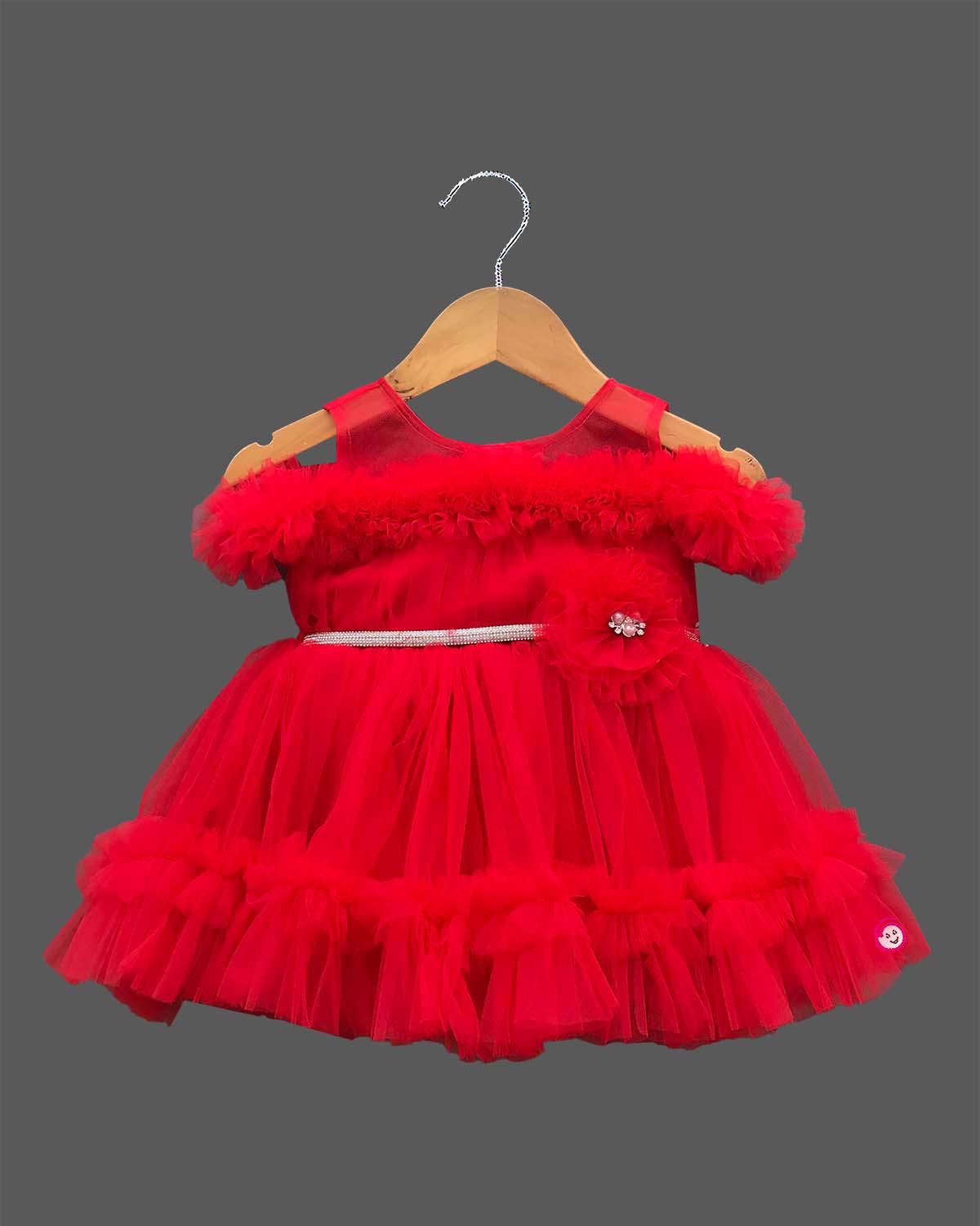Off-shoulder frill sleeve gown for a little princess with a layered ruffled hemline and sparkling belt embellishment.