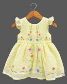 Frill sleeve organic casual frock with embroidered floral vines and baby casual wear dress styling details.