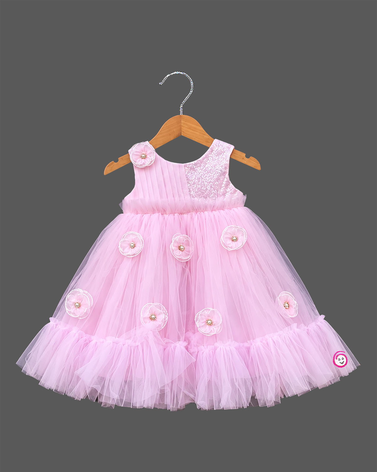 Little girl in soft pink net frock with floral appliqués and shimmer bodice for birthday parties